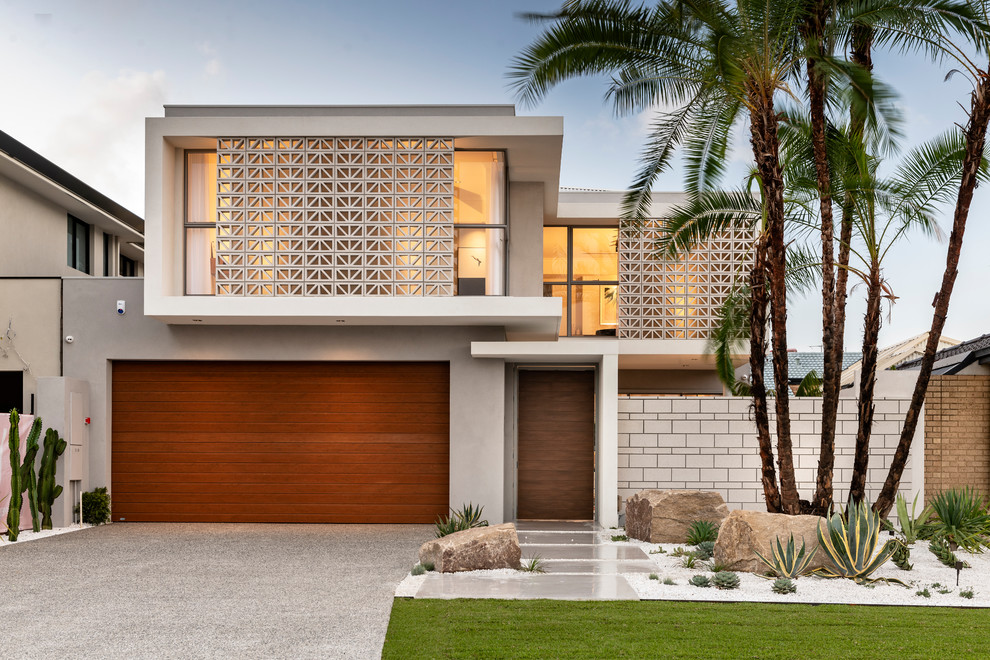 Inspiration for a contemporary two-storey beige house exterior in Perth with a flat roof.