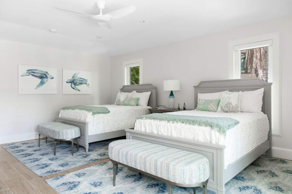 Design ideas for a large beach style gender-neutral kids' room in Tampa with white walls, porcelain floors and brown floor.