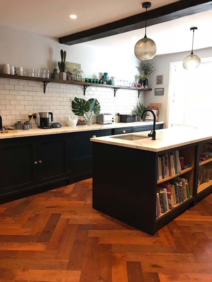 Dark blue kitchen with island and open plan shelving Traditional