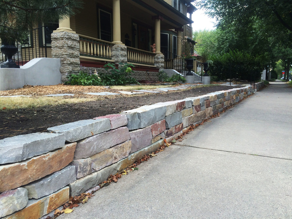 Design ideas for a mid-sized eclectic front yard garden in Minneapolis with a retaining wall.
