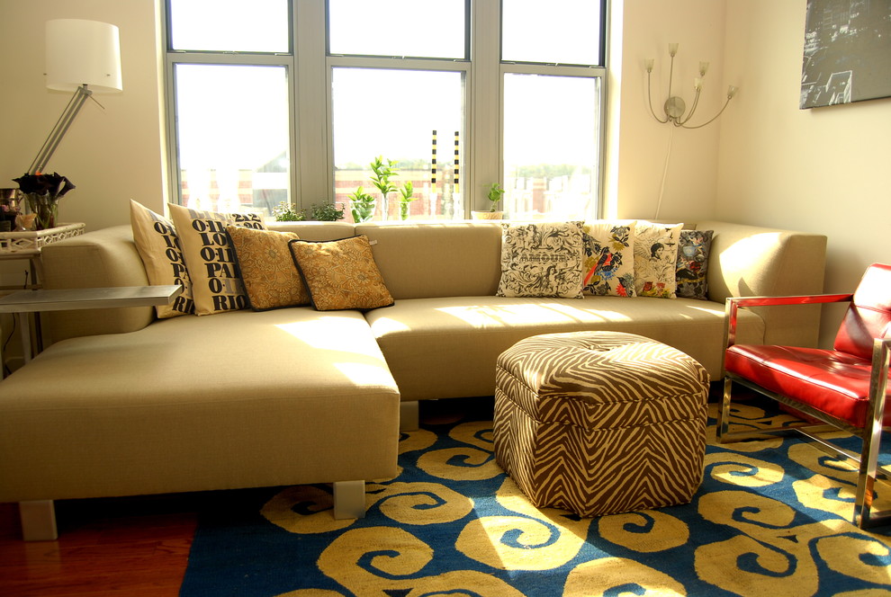 This is an example of an eclectic living room in DC Metro with beige walls.