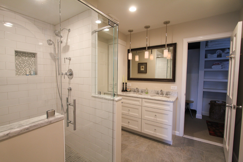Inspiration for a mid-sized transitional master bathroom in Philadelphia with white cabinets, white tile, subway tile, beige walls, an undermount sink, marble benchtops, recessed-panel cabinets, an alcove shower, a two-piece toilet and linoleum floors.