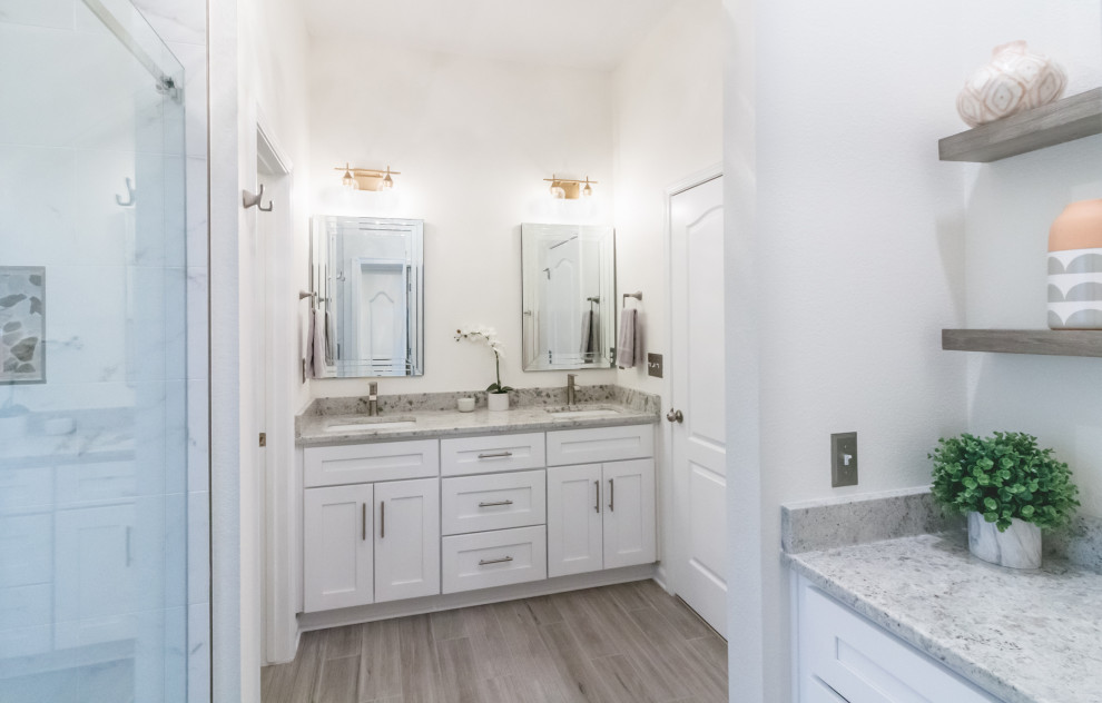 Example of a mid-sized transitional 3/4 white tile and porcelain tile gray floor, double-sink and porcelain tile bathroom design in Atlanta with white walls, a freestanding vanity, shaker cabinets, white cabinets, an undermount sink, granite countertops and gray countertops