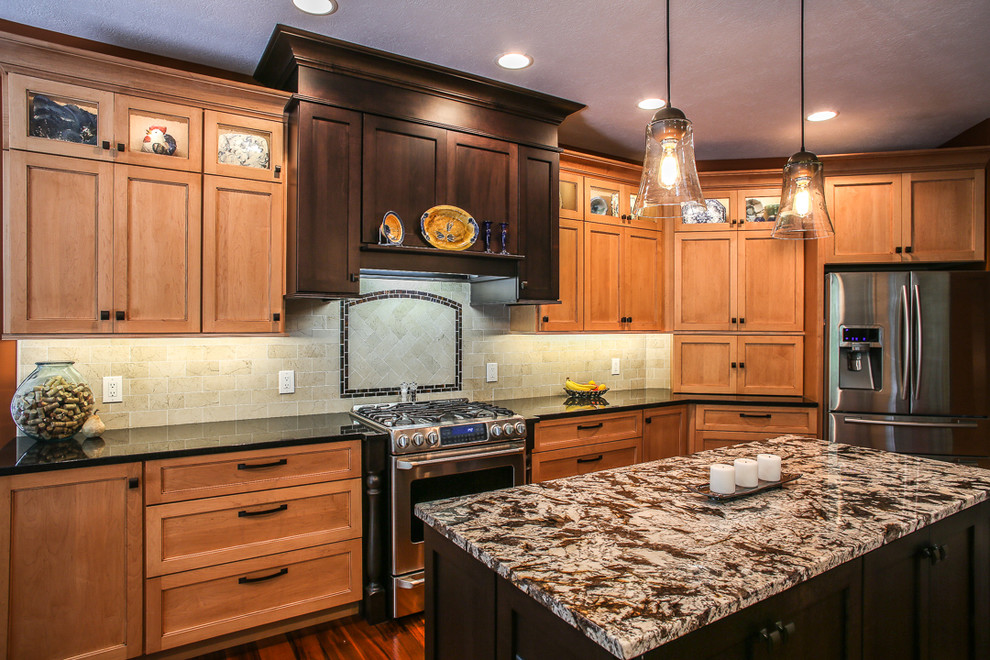 Huge transitional medium tone wood floor kitchen photo with an undermount sink, shaker cabinets, light wood cabinets, granite countertops, beige backsplash, porcelain backsplash, stainless steel appliances and an island