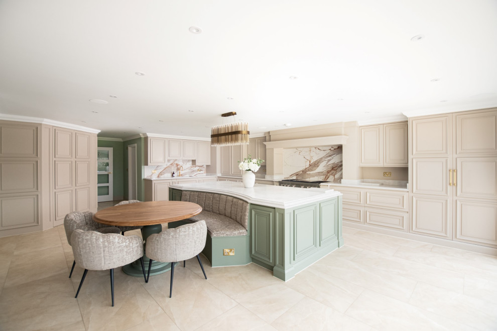 Expansive contemporary l-shaped open plan kitchen in Essex with a double-bowl sink, shaker cabinets, grey cabinets, quartz worktops, orange splashback, porcelain splashback, stainless steel appliances, travertine flooring, an island, brown floors, white worktops and a feature wall.