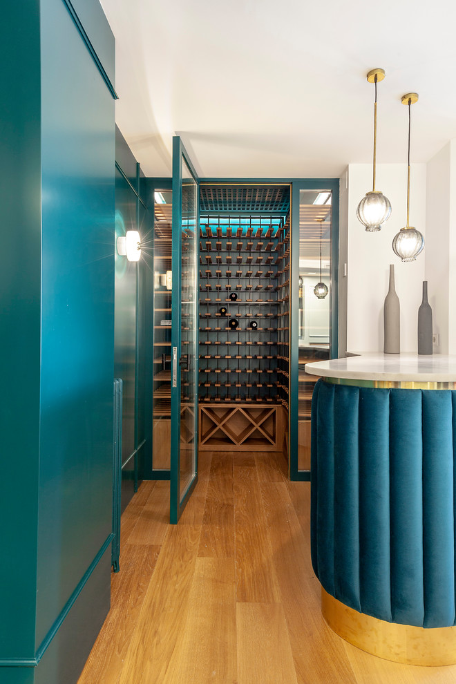 Photo of a contemporary wine cellar in Other with medium hardwood floors and storage racks.