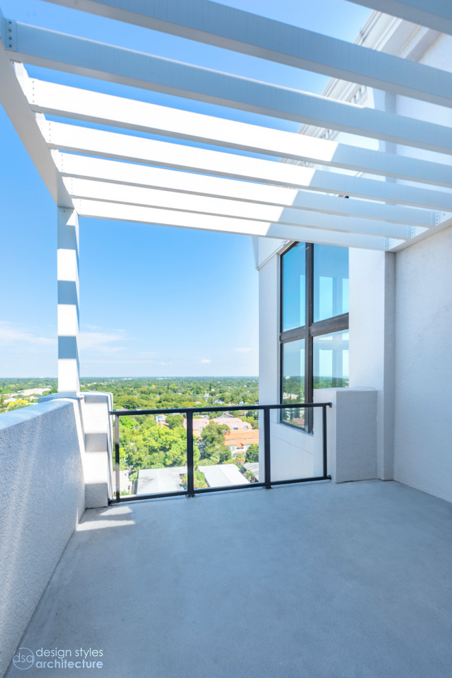 Small contemporary balcony in Tampa with a pergola and metal railing for for apartments.