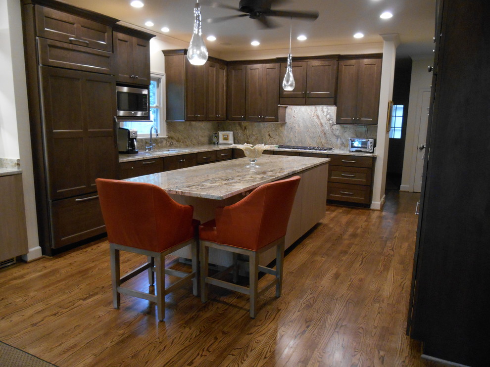 Example of a mid-sized transitional l-shaped medium tone wood floor eat-in kitchen design in Birmingham with a single-bowl sink, flat-panel cabinets, medium tone wood cabinets, granite countertops, stone slab backsplash, paneled appliances, beige walls and an island