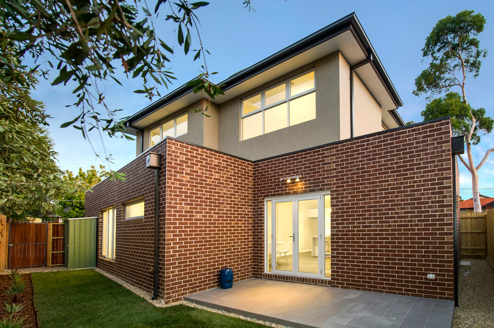 This is an example of a mid-sized contemporary two-storey brick brown exterior in Melbourne with a flat roof.