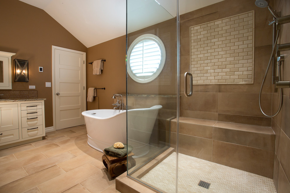 Mid-sized transitional master bathroom in Portland with shaker cabinets, white cabinets, a freestanding tub, a corner shower, a two-piece toilet, brown tile, ceramic tile, brown walls, travertine floors, an undermount sink, onyx benchtops, beige floor and a hinged shower door.
