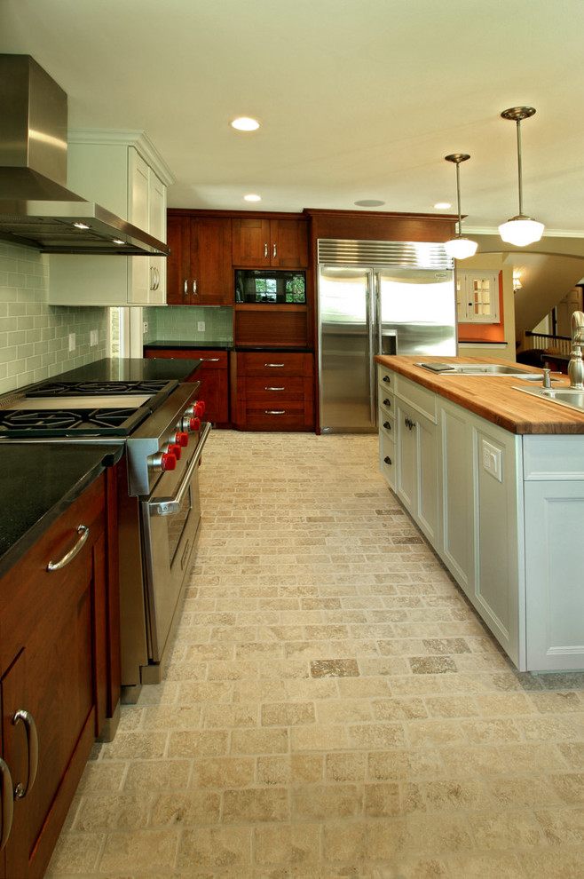 Eat-in kitchen - large transitional u-shaped limestone floor eat-in kitchen idea with a single-bowl sink, shaker cabinets, dark wood cabinets, granite countertops, blue backsplash, glass tile backsplash, stainless steel appliances and beige walls