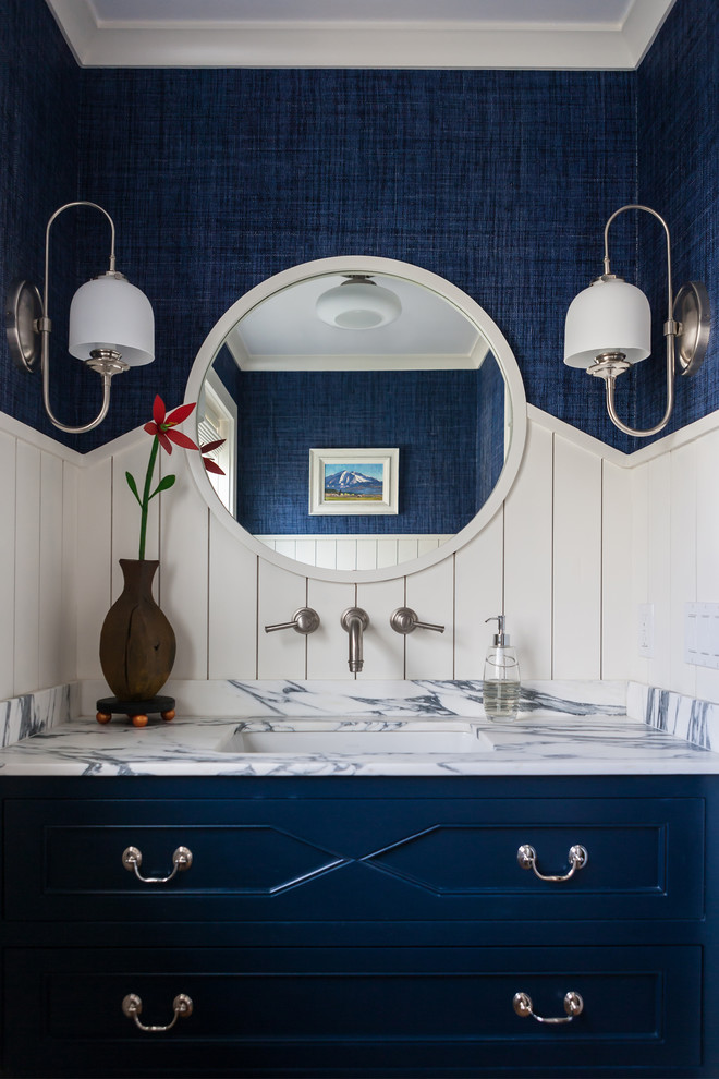 Beach style powder room in Bridgeport with blue cabinets, blue walls, an undermount sink and white benchtops.