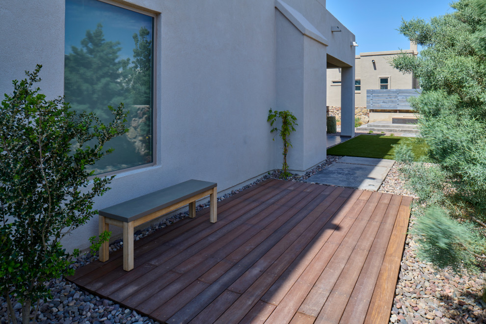 This is an example of a small contemporary side garden in Other with a pathway, decking and a wood fence.