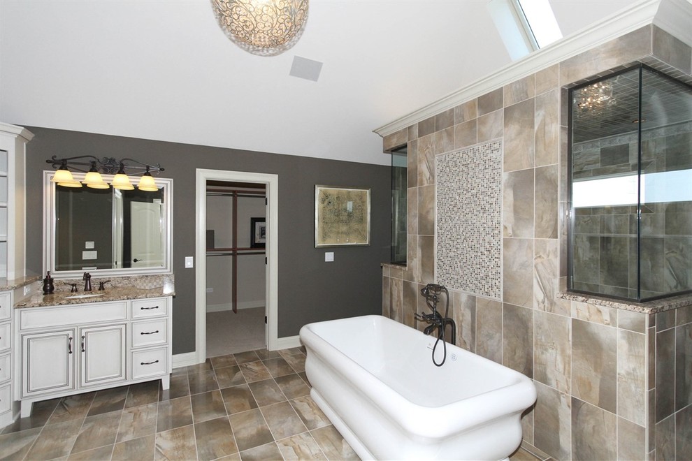 Inspiration for a huge transitional master beige tile and ceramic tile ceramic tile freestanding bathtub remodel in Chicago with an undermount sink, recessed-panel cabinets, distressed cabinets, granite countertops and gray walls