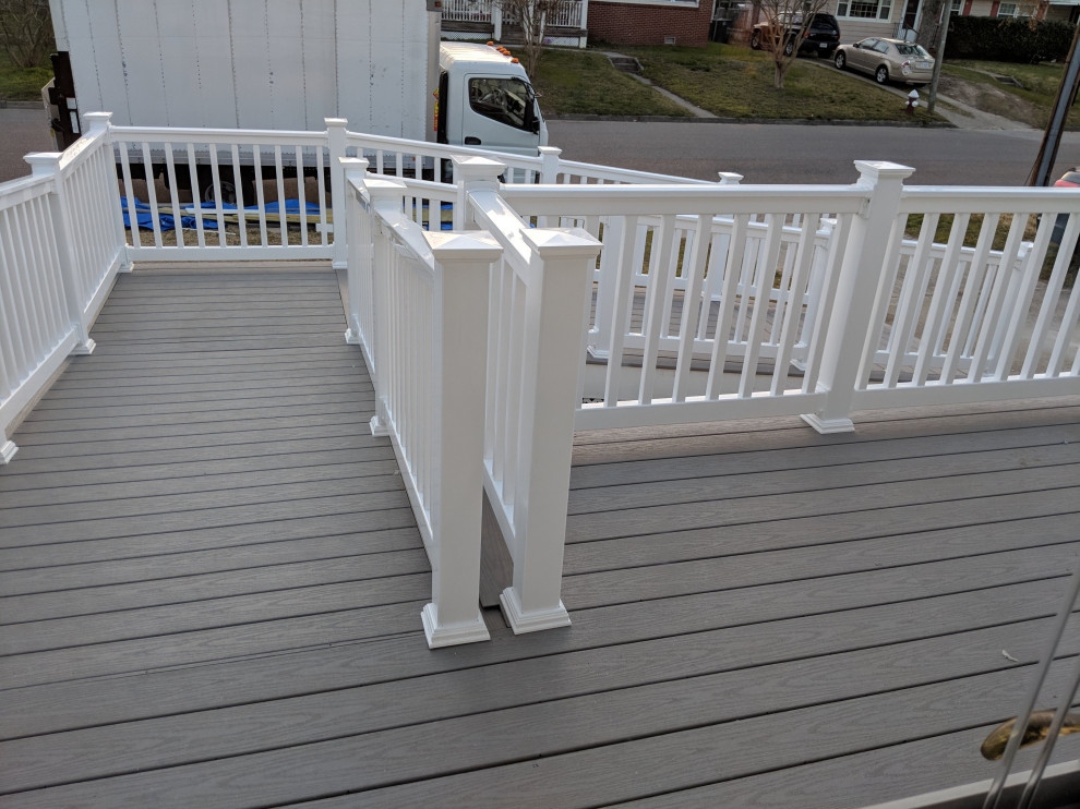 Inspiration for a large traditional front mixed railing veranda in Other with skirting and decking.