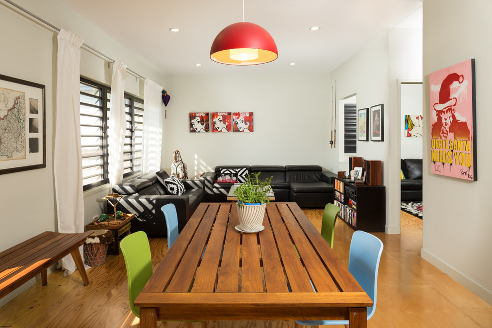 This is an example of a mid-sized contemporary open plan dining in Brisbane with white walls and light hardwood floors.