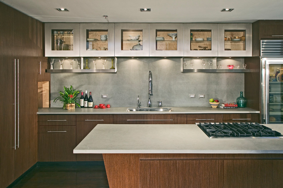 Inspiration for a large modern l-shaped separate kitchen in Chicago with an undermount sink, flat-panel cabinets, medium wood cabinets, concrete benchtops, grey splashback, stainless steel appliances, medium hardwood floors, with island, brown floor, stone slab splashback and grey benchtop.