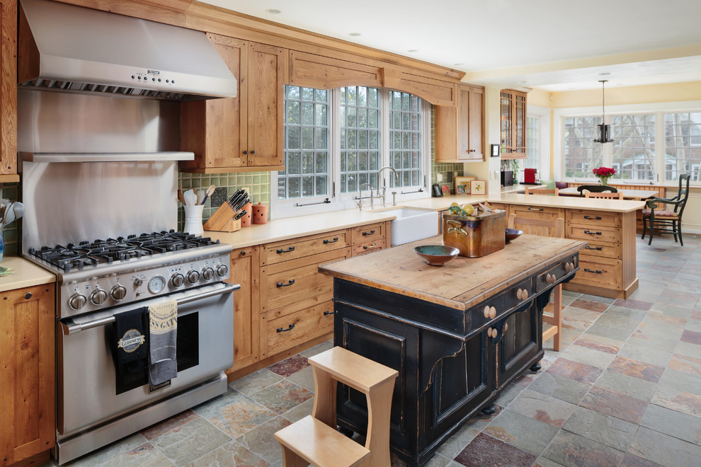 Traditional eat-in kitchen in Boston with a farmhouse sink, shaker cabinets, medium wood cabinets, green splashback, stainless steel appliances and with island.