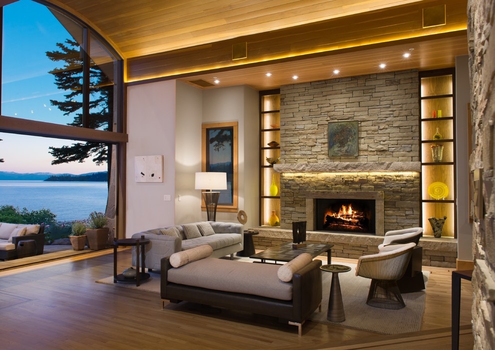 Design ideas for an expansive modern formal open concept living room in Other with white walls, light hardwood floors, a standard fireplace, a stone fireplace surround and no tv.