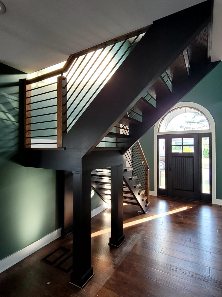 This is an example of a mid-sized contemporary wood l-shaped staircase in New York with mixed railing.