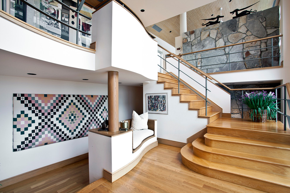 Large contemporary wood u-shaped staircase in New York with wood risers.