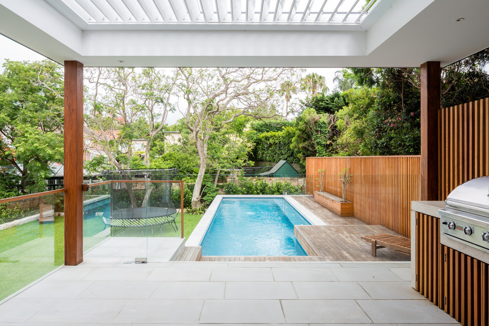 Photo of a contemporary backyard custom-shaped lap pool in Sydney.