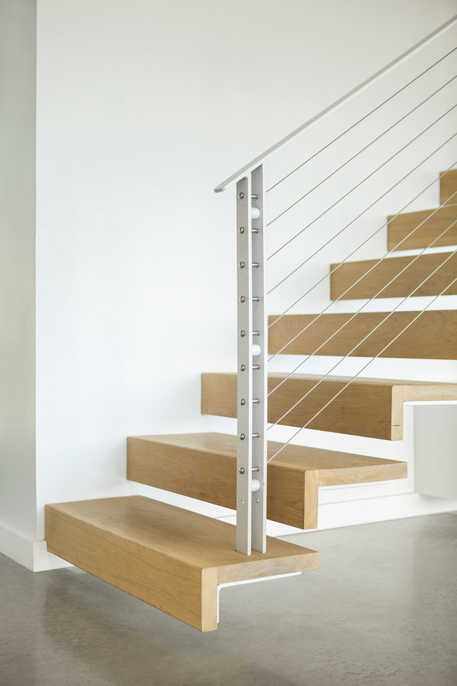 Photo of a mid-sized contemporary wood floating staircase in Boston with open risers.