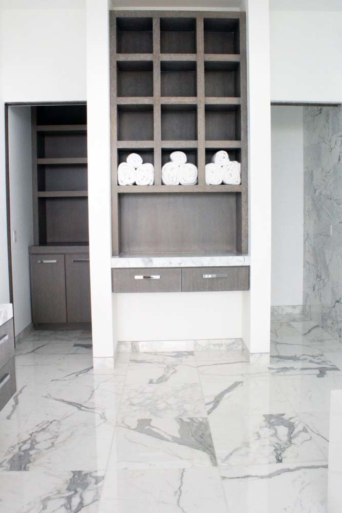 Inspiration for a large transitional master bathroom in Los Angeles with open cabinets, brown cabinets, white tile, marble, white walls, marble floors and white floor.