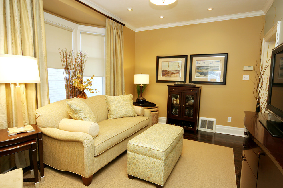 Mid-sized contemporary enclosed family room in Toronto with dark hardwood floors, a freestanding tv and yellow walls.
