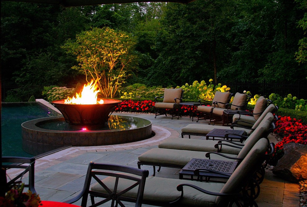 Large traditional backyard full sun garden in Detroit with a fire feature and natural stone pavers.