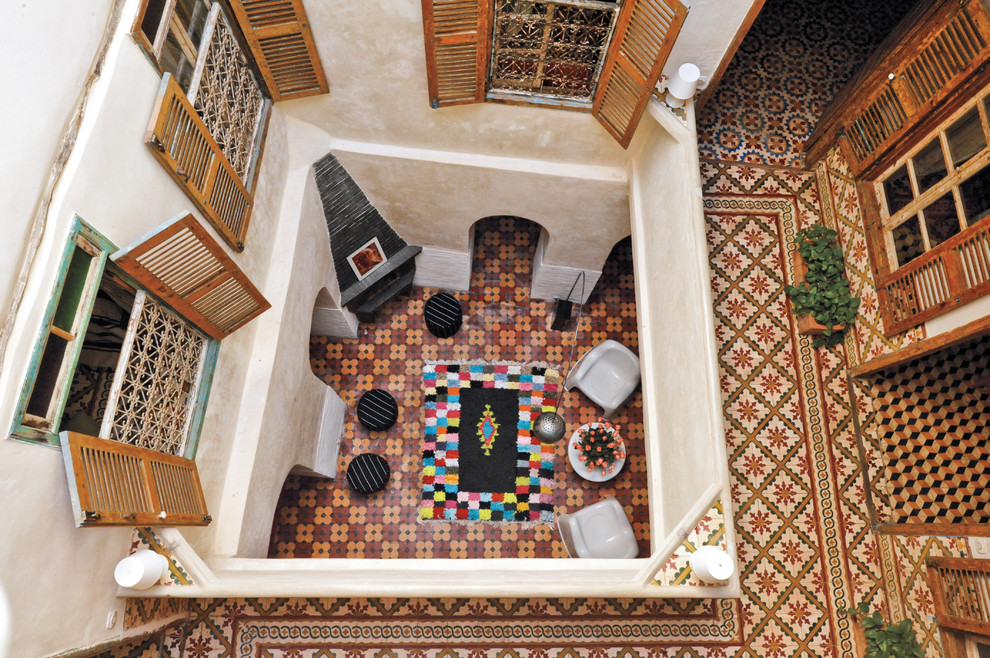 Inspiration for a mediterranean courtyard patio in New York with tile and no cover.