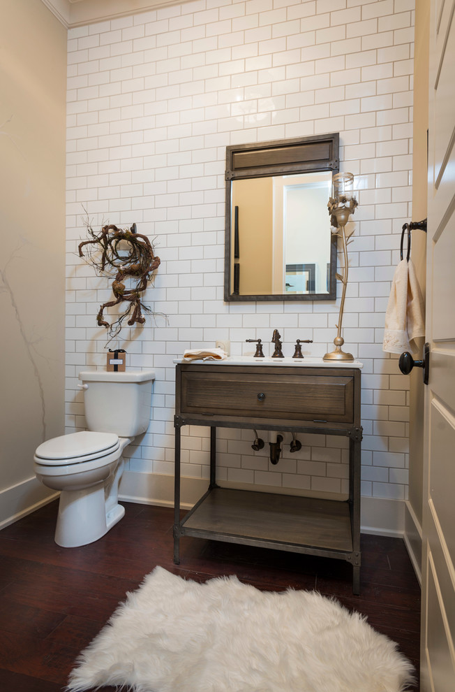 Design ideas for a small arts and crafts bathroom in Other with open cabinets, dark wood cabinets, a one-piece toilet, white tile, ceramic tile, beige walls, dark hardwood floors, a drop-in sink and granite benchtops.