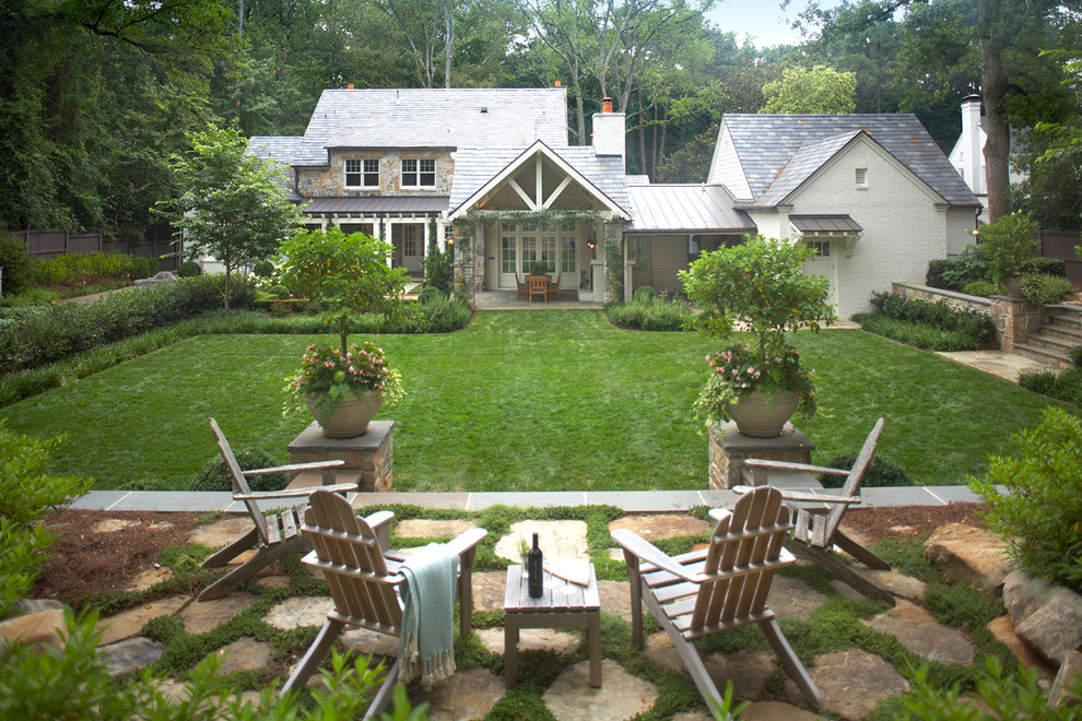 Traditional backyard garden in Atlanta with natural stone pavers.
