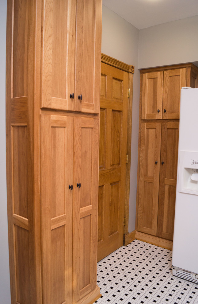 Mid-sized ornate ceramic tile enclosed kitchen photo with an undermount sink, shaker cabinets, light wood cabinets, granite countertops, white backsplash, ceramic backsplash, white appliances and an island