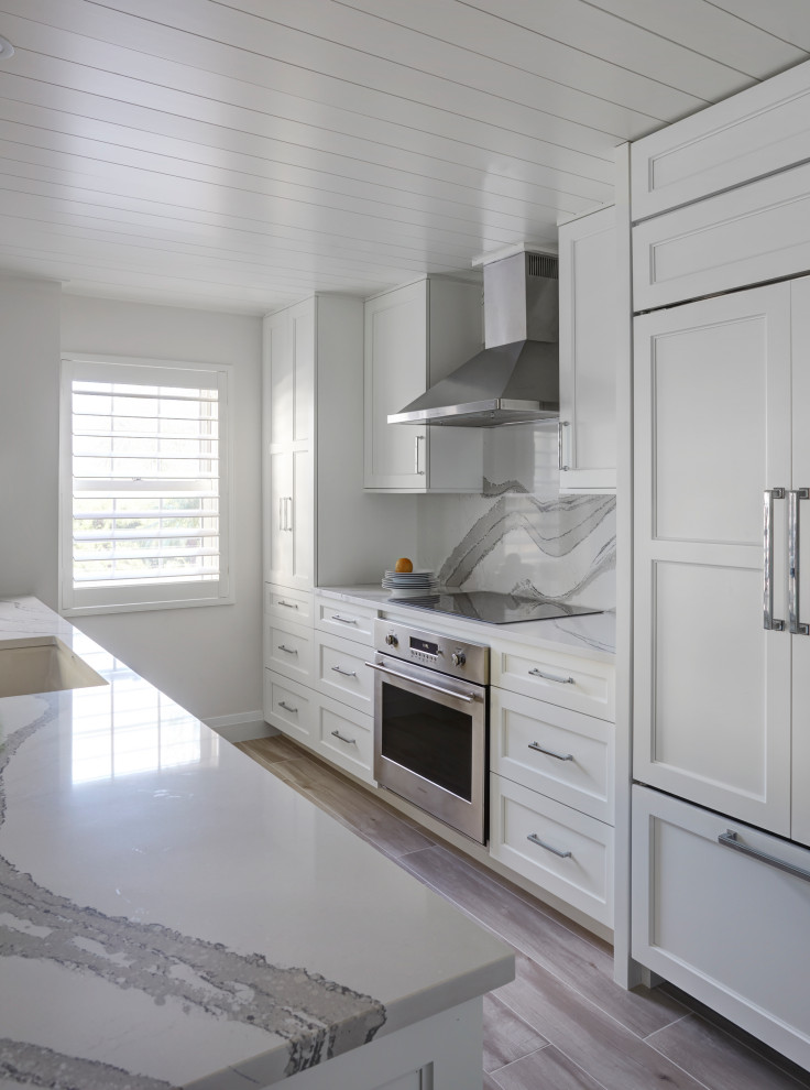 This is an example of a mid-sized beach style galley open plan kitchen.