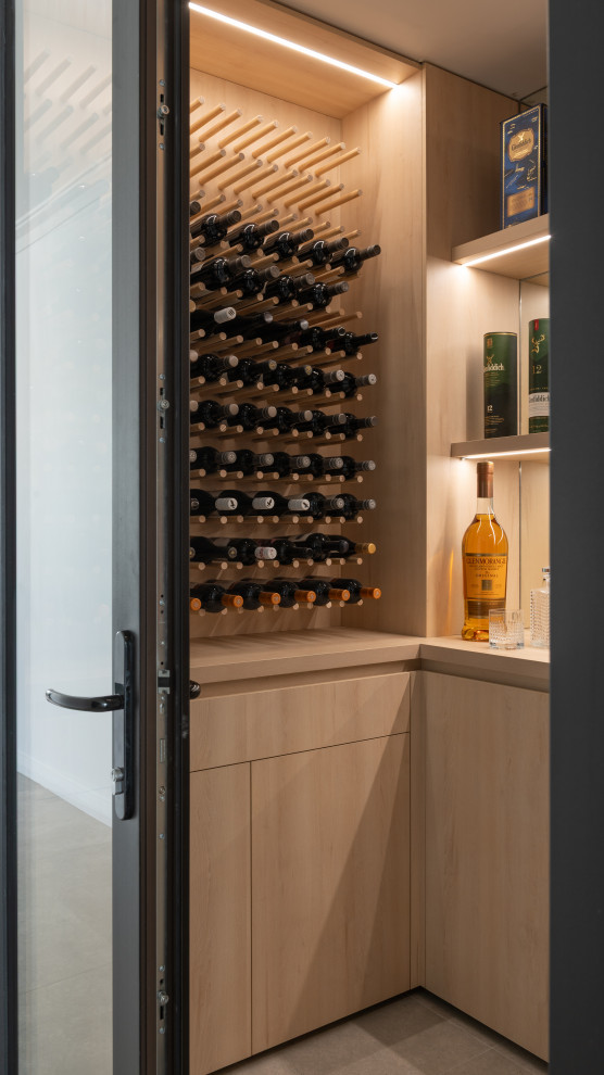 Contemporary eat-in kitchen in Perth with black cabinets, solid surface benchtops, grey splashback, stone slab splashback, black appliances, with island and grey benchtop.