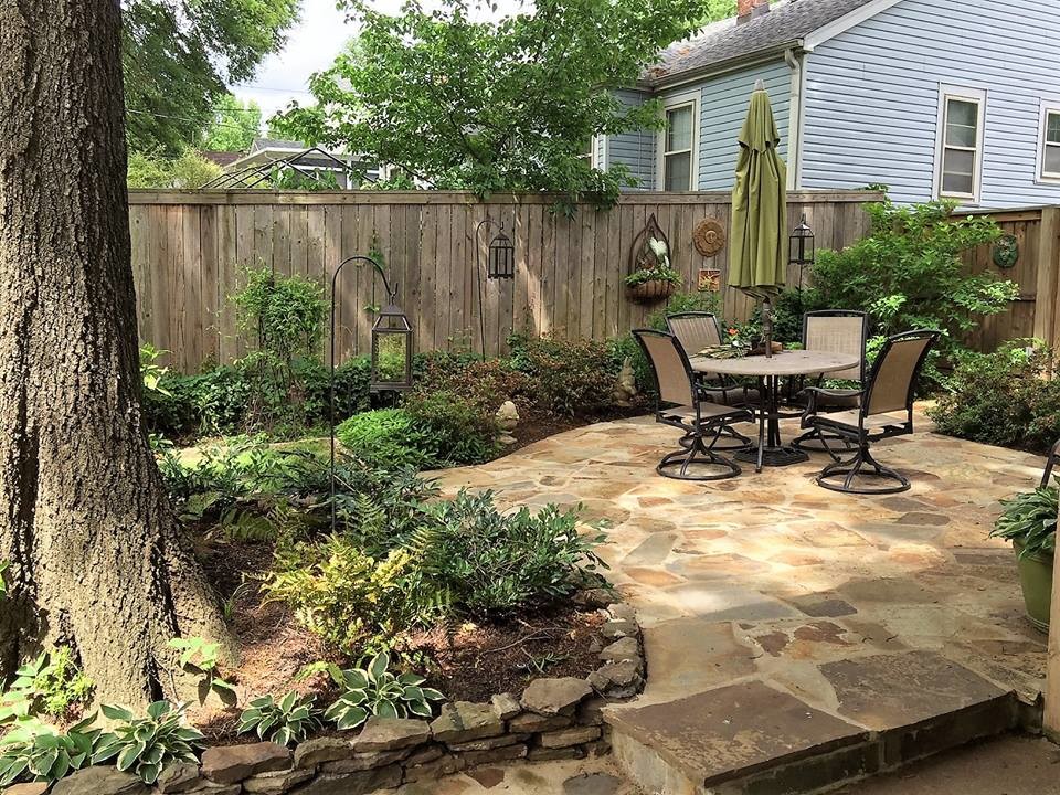 Mid-sized transitional backyard patio in Other with natural stone pavers and no cover.