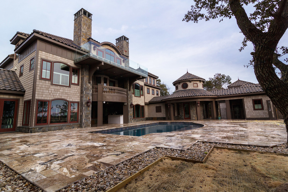 Example of a mid-sized transitional beige three-story vinyl gable roof design with a tile roof