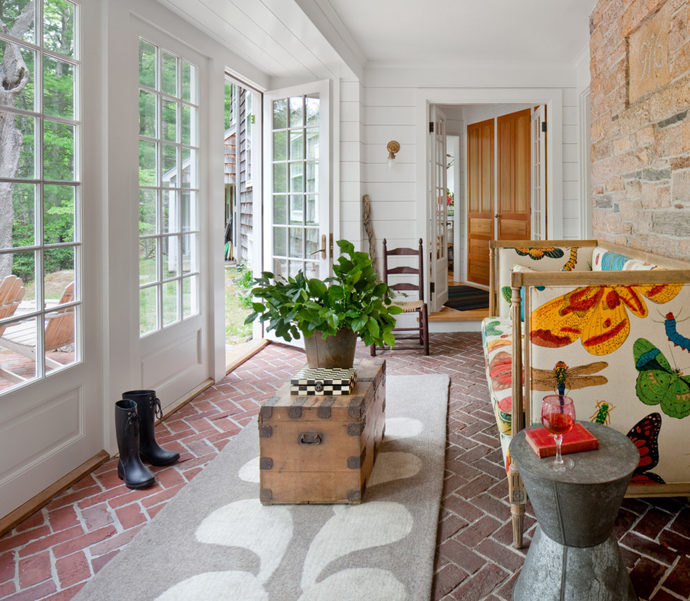 Inspiration for a country sunroom in Providence with brick floors, a standard ceiling and red floor.