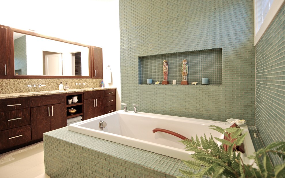 Mid-sized midcentury master bathroom in Minneapolis with flat-panel cabinets, medium wood cabinets, a drop-in tub, an open shower, a one-piece toilet, blue tile, glass tile, white walls, ceramic floors, an undermount sink and granite benchtops.