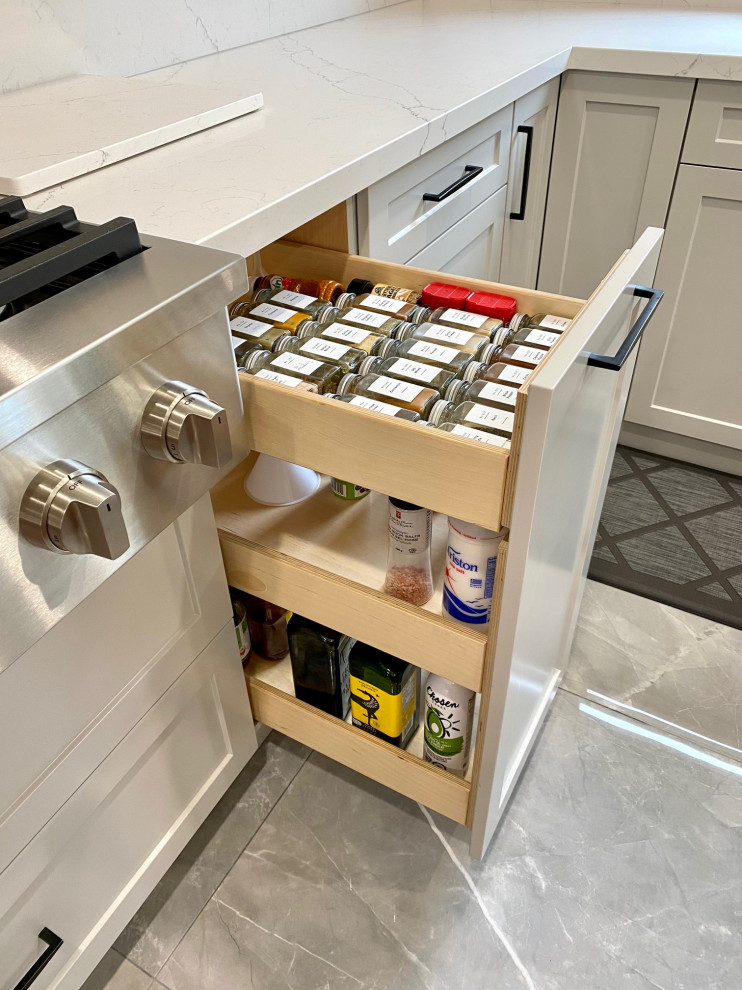 Mid-sized transitional l-shaped porcelain tile open concept kitchen photo in Toronto with an undermount sink, shaker cabinets, gray cabinets, quartz countertops, white backsplash, quartz backsplash, stainless steel appliances, an island and white countertops