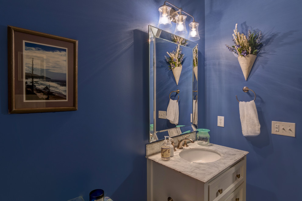 Mid-sized traditional bathroom in Indianapolis with furniture-like cabinets, grey cabinets, an alcove tub, a shower/bathtub combo, a one-piece toilet, gray tile, blue walls, ceramic floors, an undermount sink, granite benchtops, black floor, a shower curtain and grey benchtops.