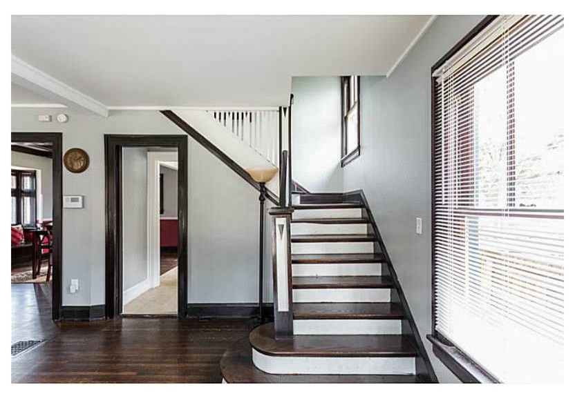 Design ideas for a large classic wood l-shaped staircase in Indianapolis with painted wood risers.