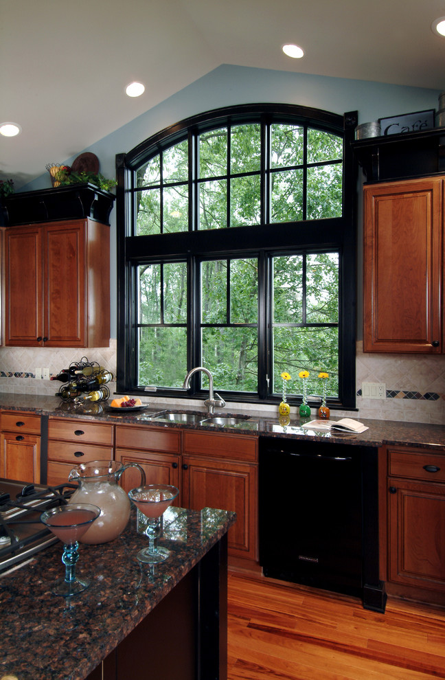 Mid-sized elegant single-wall medium tone wood floor eat-in kitchen photo in Grand Rapids with a double-bowl sink, recessed-panel cabinets, dark wood cabinets, granite countertops, gray backsplash, stone tile backsplash, stainless steel appliances and an island