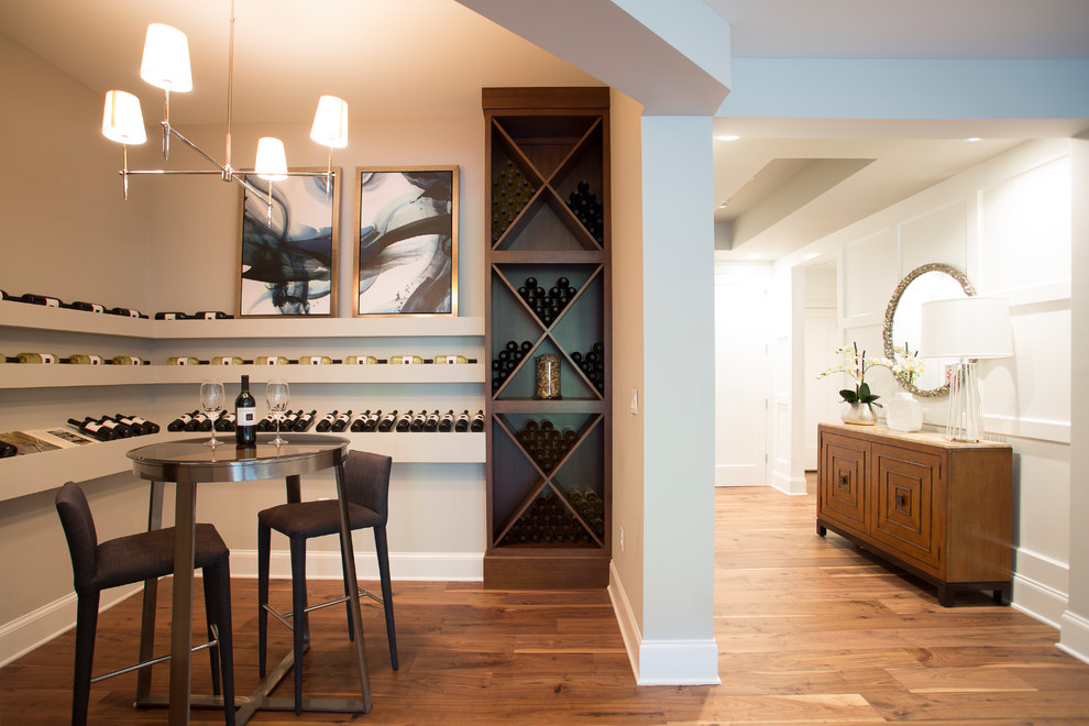 Photo of a mid-sized contemporary wine cellar in DC Metro with dark hardwood floors, display racks and brown floor.