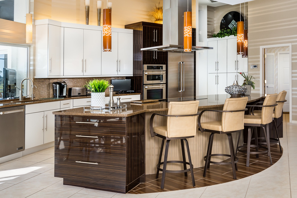 This is an example of a large contemporary u-shaped eat-in kitchen in Miami with flat-panel cabinets, white cabinets, stainless steel appliances, ceramic floors, with island, quartz benchtops, brown splashback, a double-bowl sink, matchstick tile splashback and brown benchtop.