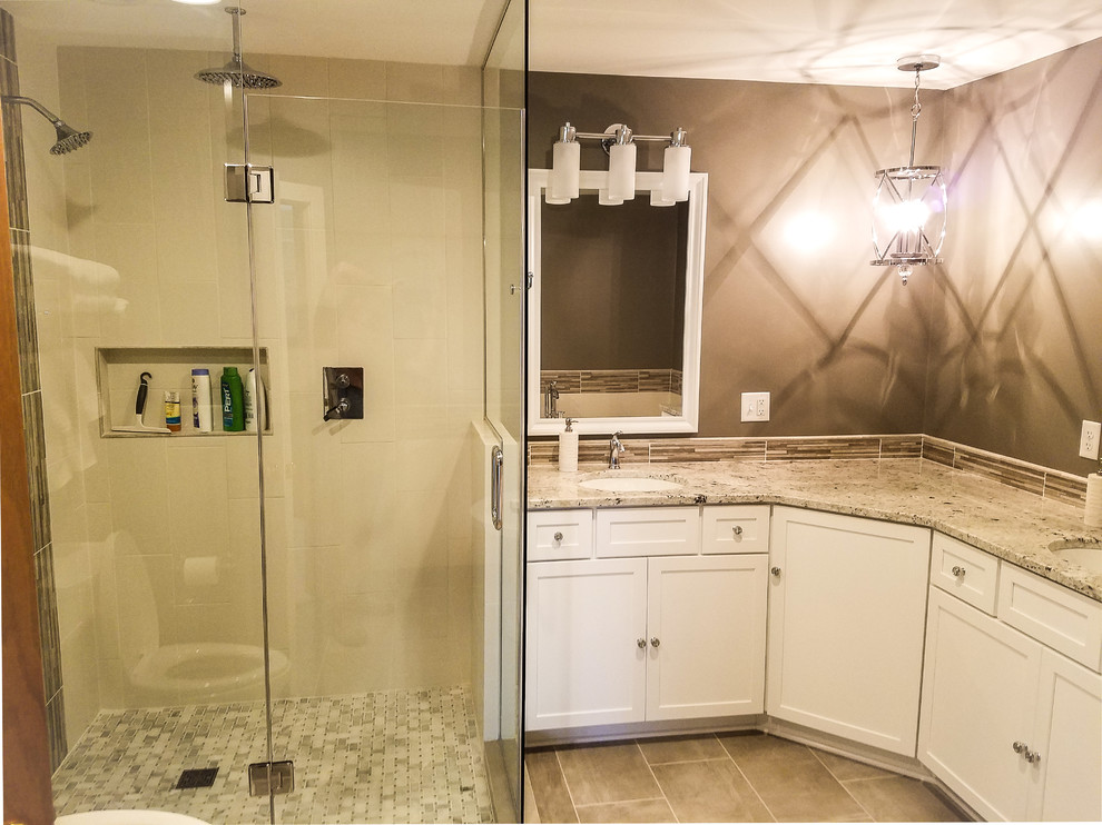 Example of a large transitional master multicolored tile and ceramic tile porcelain tile and gray floor freestanding bathtub design with shaker cabinets, white cabinets, a two-piece toilet, gray walls, an undermount sink, granite countertops and a hinged shower door