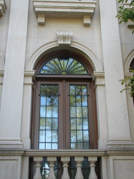 This is an example of a mediterranean three-storey exterior in Chicago with stone veneer.