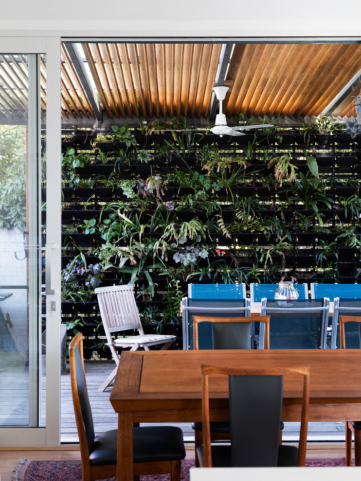 Large contemporary deck in Melbourne with a roof extension.