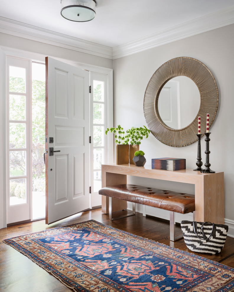 Photo of a transitional foyer in New York with grey walls, medium hardwood floors, a single front door and a white front door.